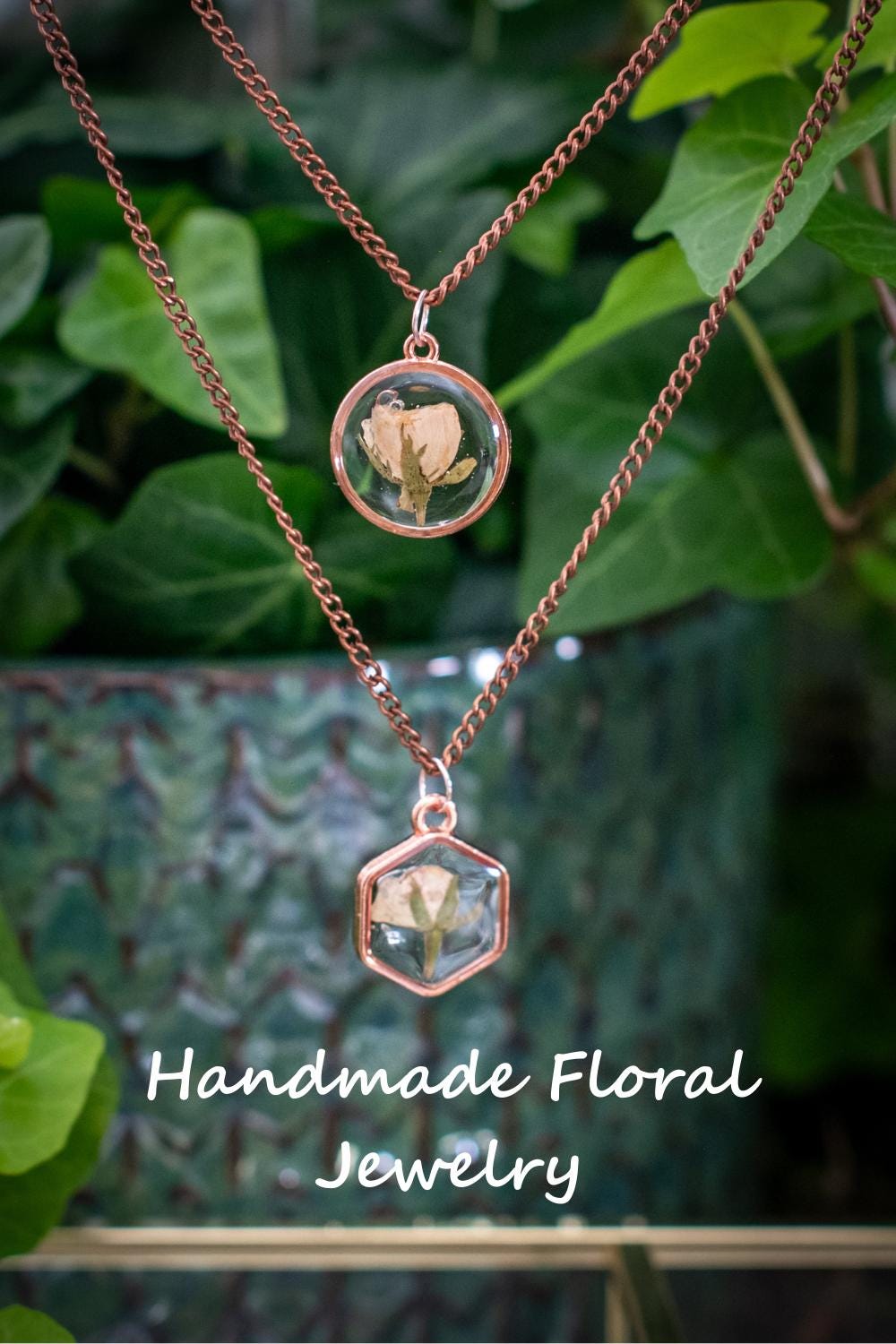 Close-up of resin rose necklace on pink background with βHappy Birthdayβ note. A meaningful flower gift that never wilts.