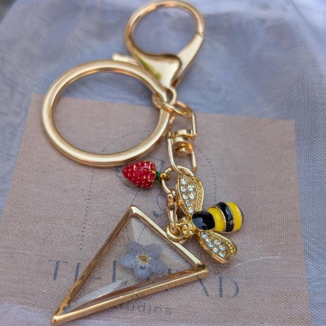 Triangle gold keychain with real dried flower bee charm and strawberry accessory aesthetic gift for plant lover or garden friend
