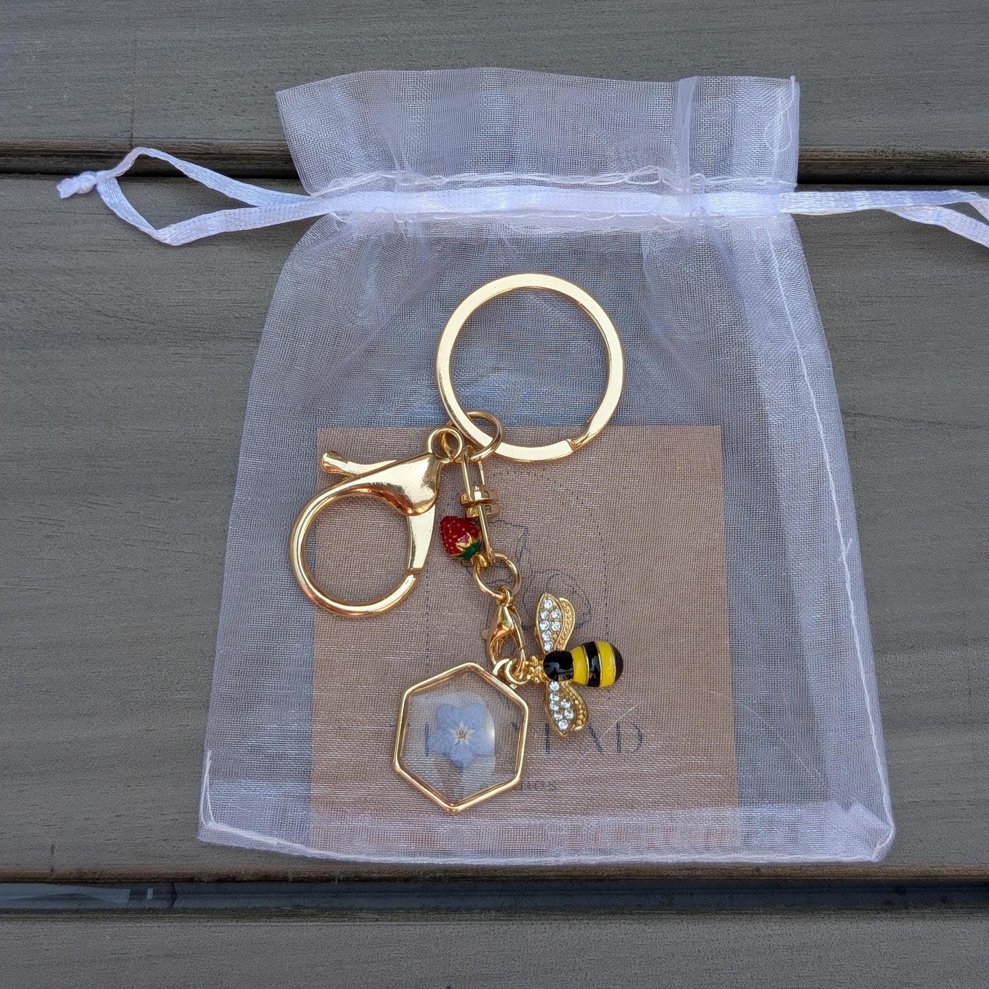 Garden inspired keychain with dainty triangle resin flower charm gold bee accessory and tiny strawberry for spring gift giving
