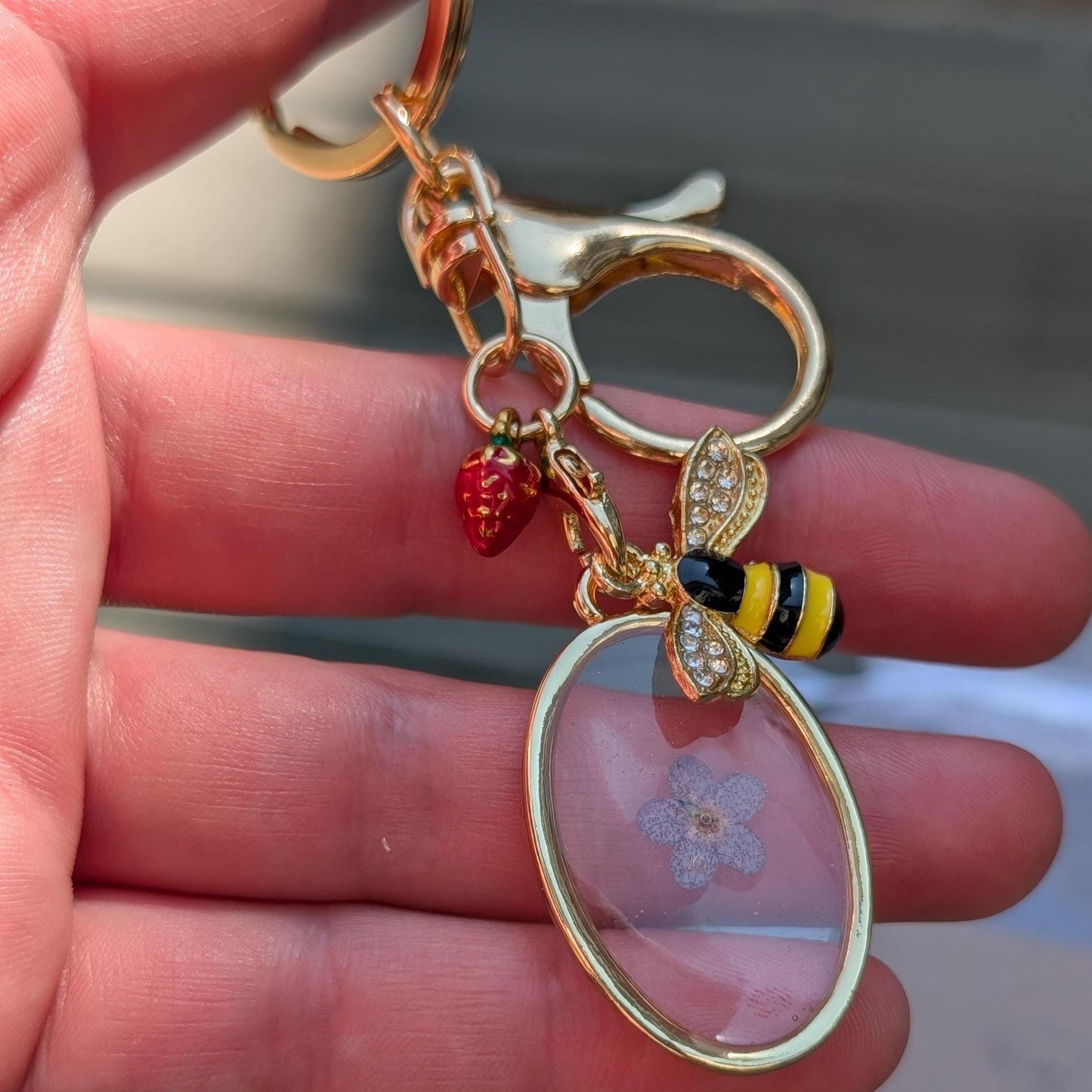 Cottagecore keychain gold triangle pressed flower pendant with bumblebee charm and summer berry detail for aesthetic gift idea