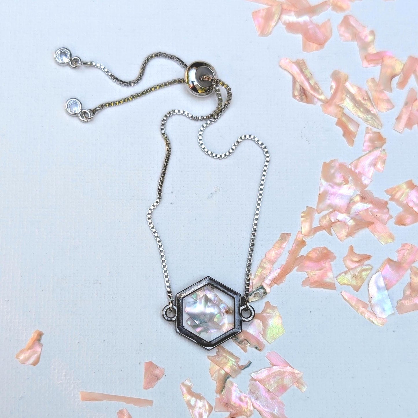 Coastal inspired jewelry gift with light pink shell in hexagon frame