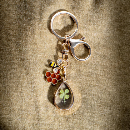 good luck keychain gold bee real pressed flowers four leaf clover honeycomb positivity safe travels new opportunities graduation new job spiritual charm motivational keepsake botanical gift handmade gift lucky charm positive energy