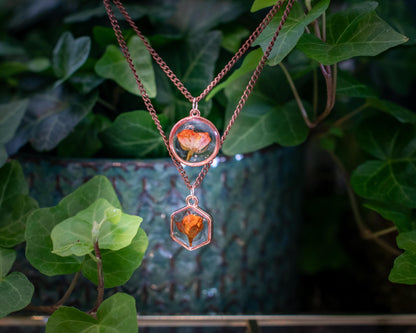 A nature-inspired resin necklace showcasing a real flower encased in crystal-clear resin. This delicate rose pendant is framed in rose gold and hangs from an adjustable chain, making it a meaningful gift for her that’s both romantic and timeless.