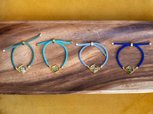 Boho resin bracelet featuring real preserved clover gold hexagon charm adjustable cord nature-inspired festival accessory handmade jewelry gift