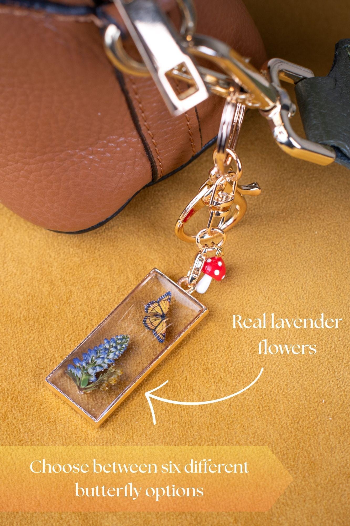 Unique Bag Charm Preserved Lavender Butterfly Design Gold Tone Pendant Nature Inspired Accessory Cottage Core Style Fairy Garden Theme Mushroom Detail Resin Art Beautiful Purse Decoration Handcrafted Gift Item Botanical Collection