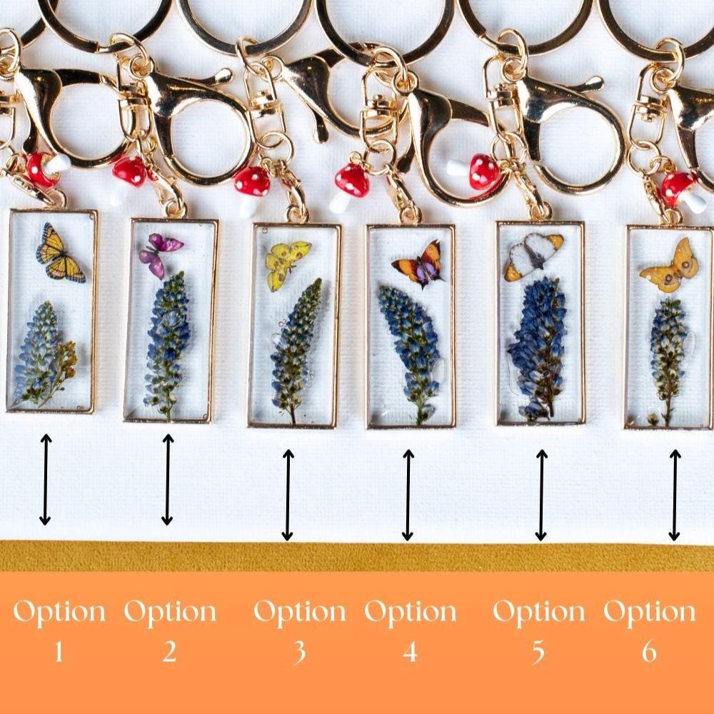 Fairy Garden Pendant Preserved Flower Charm Gold Tone Design Butterfly Lavender Detail Nature Inspired Collection Cottage Style Aesthetic Mushroom Accent Beautiful Bag Accessory Resin Art Piece Unique Gift Item Botanical Decoration