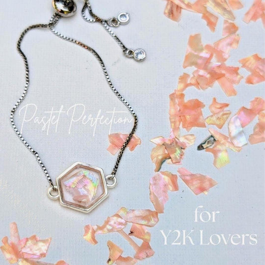 Pink shell hexagon bracelet laid on iridescent background for y2k aesthetic
